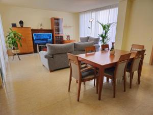 a living room with a table and chairs and a couch at House TAMARIT PLAYA in Tarragona