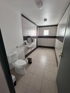 a bathroom with a toilet and a sink at Villa Rose-May in Saint-Pierre