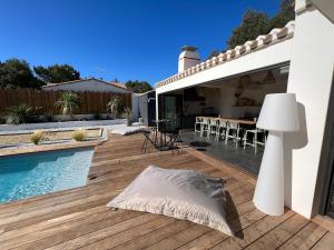 a backyard with a swimming pool and a house at Villa La Bosse Ile de Noirmoutier pour 10 personnes in LʼÉpine