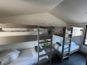 a room with two bunk beds and a ladder at Villa La Bosse Ile de Noirmoutier pour 10 personnes in LʼÉpine +43 photos