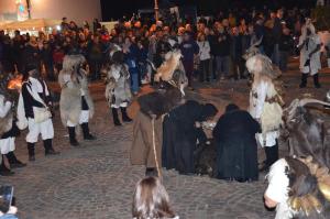 a group of people dressed in costumes standing in a crowd at Casa Rosa in Taquisara