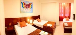 Postel nebo postele na pokoji v ubytování Hostal Macambo