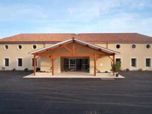 a building with a parking lot in front of it at Coup 2 Foudres in Saint-Jean-de-Blaignac