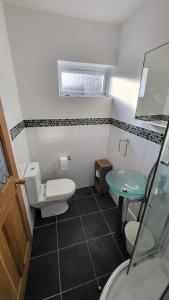 a bathroom with a toilet and a sink at Home for one! in Midford