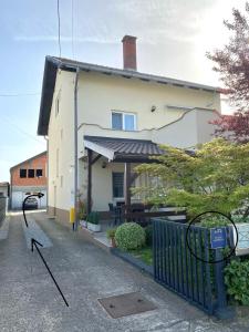 a house with a blue fence in front of it at Apartman Lucija in Gradići
