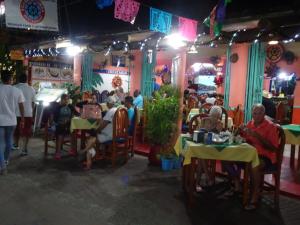 eine Gruppe von Menschen, die an Tischen in einem Restaurant sitzen in der Unterkunft Beautiful Casita at La Madera Beach, Zihuantanejo in Zihuatanejo