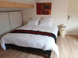 a bedroom with a large bed with white sheets and pillows at GITE 2 personnes avec piscine in Le Bosc