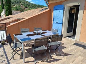a table and chairs sitting on a patio at GITE 2 personnes avec piscine in Le Bosc