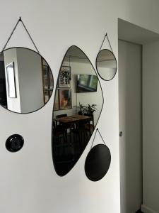 a mirror hanging on a wall with a dining room at Metro Trocka Apartment in Warsaw