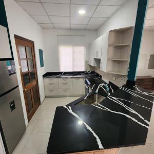 a kitchen with a black and white counter top at Little Bern #1, your little oasis with pool access in San Mateo