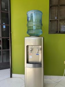 a glass container sitting on top of a refrigerator at Little Bern #1, your little oasis with pool access in San Mateo