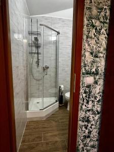 a bathroom with a shower and a toilet at Sloneczny pokoj in Świnoujście +16 photos