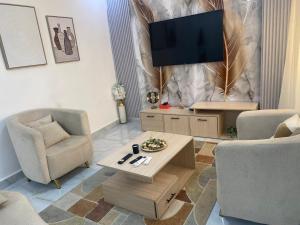 a living room with a flat screen tv on a wall at La gloire House in Dakar