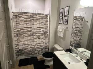 a bathroom with a shower and a toilet and a sink at Giaviana's in Atlanta +46 photos