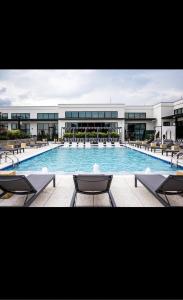 a large swimming pool with chairs and a building at Giaviana's in Atlanta