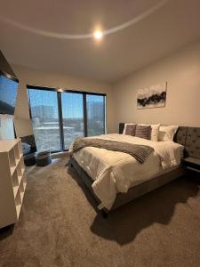 a bedroom with a large bed and a large window at Giaviana's in Atlanta