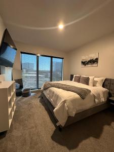 a bedroom with a large bed and a large window at Giaviana's in Atlanta
