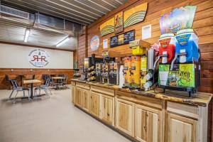 a restaurant with a counter with a lot of drinks at Roaring River - Family Adventure Tents #12 and #13 in Cassville +10 photos