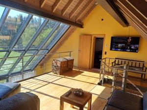 a living room with a large glass window at Haus Burg, Ferienhaus in Bongard