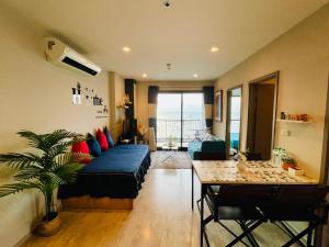 a living room with a blue couch and a table at The base Central 2 bed 1 bath 514 by Numam in Pattaya
