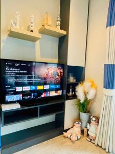 a television in a living room with two stuffed animals at The base Central 2 bed 1 bath 514 by Numam in Pattaya