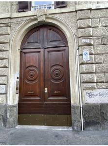 a large wooden door on a building with graffiti at Cozy Colosseo in Rome