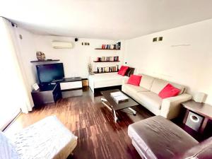 sala de estar con sofá blanco y almohadas rojas en Top House Murat con idromassaggio, en Bari