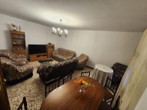 a living room with a table and chairs at La Casona de Tati in Villanueva de Alcardete