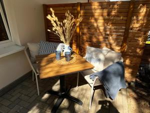 a table and chairs in a room with a wooden wall at Bungalow Blue Sea im Green Village Benz in Benz