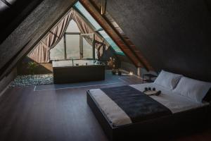 a bedroom with a large bed and a bath tub at WOODLİFE BUNGALOv in Rize +40 photos