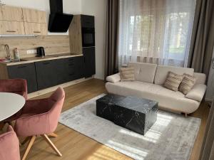 a living room with a couch and a table at Ferienwohnung Ferlach TOP1 in Ferlach