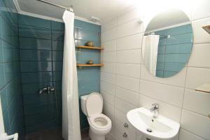 a bathroom with a toilet and a sink and a mirror at The SPiTi Project 33 in Kavala