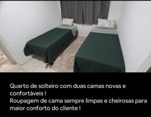 a room with two green beds in a room at Comfortable apartment in Franca