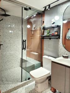 a bathroom with a toilet and a shower and a sink at appartement de luxe réservée aux familles in Meknès