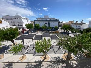 a park with trees and benches in a city at Apartamento Baluarte in Sanlúcar de Barrameda