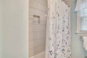 a bathroom with a shower with a shower curtain at 1 Mi to Beach Cape Cod Escape with Yard! in West Dennis +23 photos