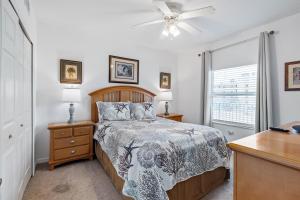 a bedroom with a bed and a ceiling fan at Coastal 3-bed 2-bath Condo-new Smyrna Beach Fl in New Smyrna Beach +69 photos