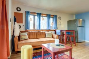a living room with a couch and a table at Walk to Trails Artsy Mtn-View Getaway in Vernon! in Vernon