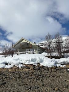 a house with snow in front of it at Fjord & Flame in Tromsø