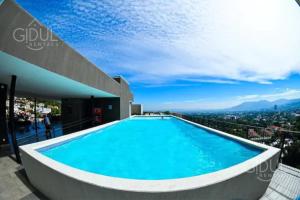 a swimming pool on top of a building at Infinity Pool Apartment in San Salvador