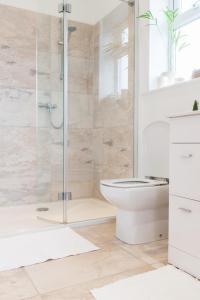 a bathroom with a glass shower and a toilet at Padstow Bed & Breakfast in Padstow