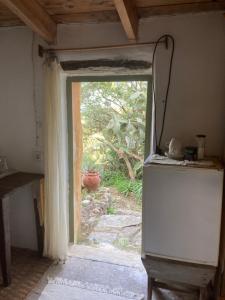 an open door to a kitchen with a refrigerator at Circadia in Prongíon