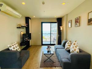 a living room with two couches and a table at The base Condo luxury 2 bed 2 bathroomby Numam in Pattaya
