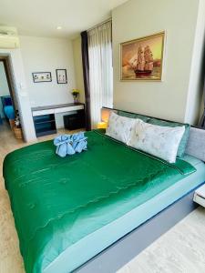 a large green bed in a room at The base Condo luxury 2 bed 2 bathroomby Numam in Pattaya +58 photos