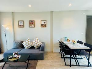 a living room with a couch and a table at The base Condo luxury 2 bed 2 bathroomby Numam in Pattaya