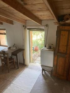 a kitchen with a refrigerator and a table and a window at Circadia in Prongíon