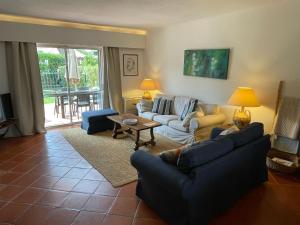 a living room with two couches and a table at SOLAR DO GOLFE - Vilamoura in Vilamoura
