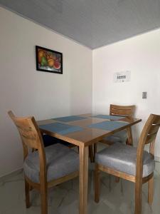 a dining room table with two chairs and a table at Mirador M S Paipa 70m2 in Paipa +2 photos