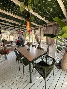 a table and chairs on a deck with a table and a light at Iris Holiday Homes in Biograd na Moru