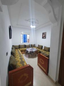 a living room with a couch and a table at Martil in Martil